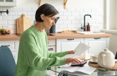 Senior adult woman handling finance from home.