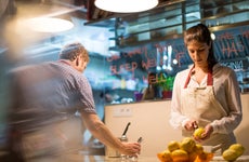 Two restaurant owners work in their kitchen
