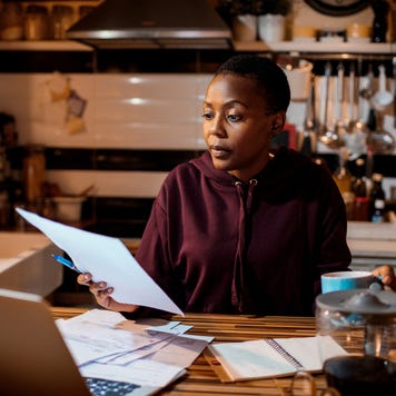 Young woman doing home finances in the evening