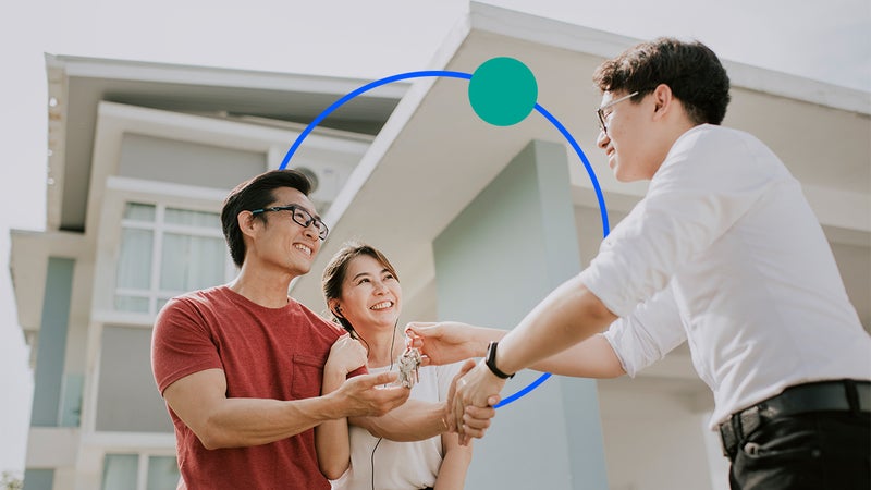 Image of a couple shaking hands with a realtor handing them keys with illustrated graphic features