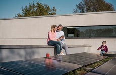 Family sitting in a porch with solar panel
