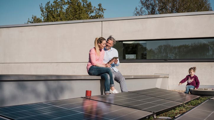 Family sitting in a porch with solar panel
