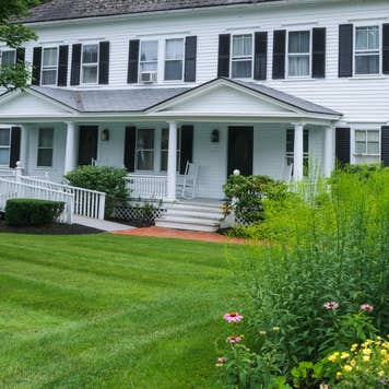 A white house with a big garden and a handicapped entrance