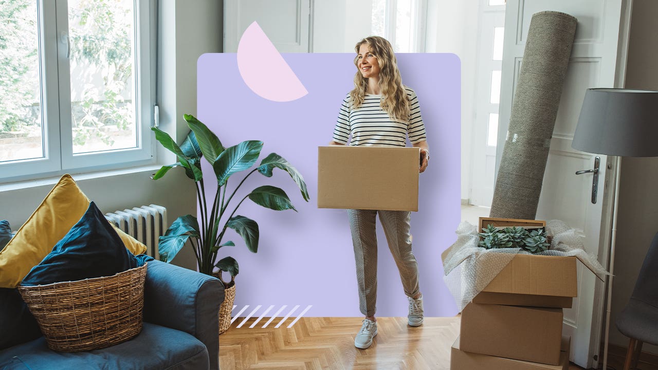 Woman carrying a box into a room