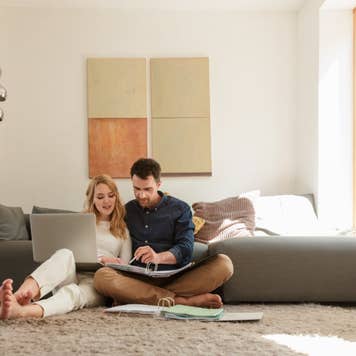 Couple with laptop looking at paperwork