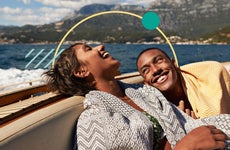 Illustration of a happy couple on the back of a boat.