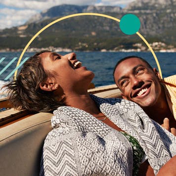 Illustration of a happy couple on the back of a boat.