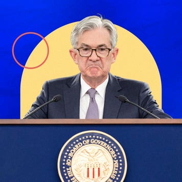 Jerome Powell at frowning while standing at podium