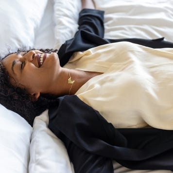 woman laying down on a bed