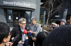 Members of the media interview a Silicon Valley Bank customer outside of the bank office