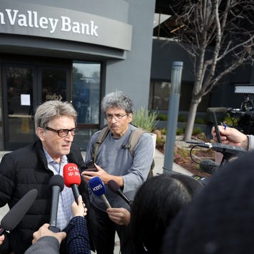 Members of the media interview a Silicon Valley Bank customer outside of the bank office