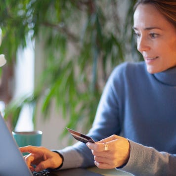 Person using credit card at laptop