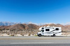 Camper in rolling Hills with Eastern Sierras in the Distance from Hwy 395