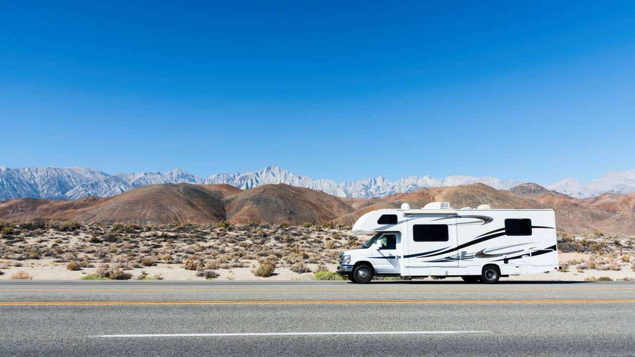 Camper in rolling Hills with Eastern Sierras in the Distance from Hwy 395