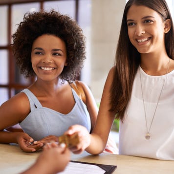 Shot of two friends checking in to a day spa