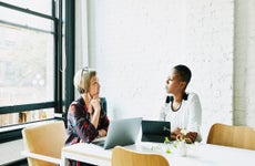 Businesswomen discussing project in office conference room