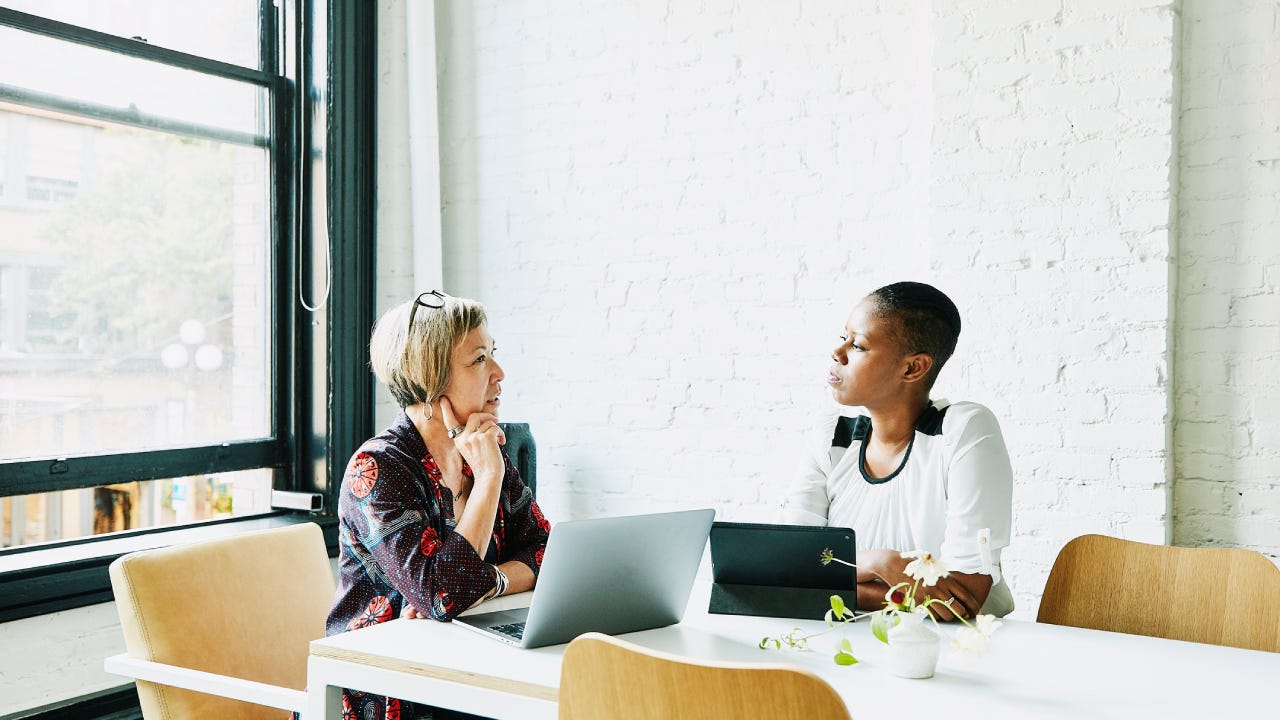 Businesswomen discussing project in office conference room