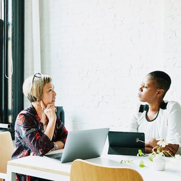 Businesswomen discussing project in office conference room