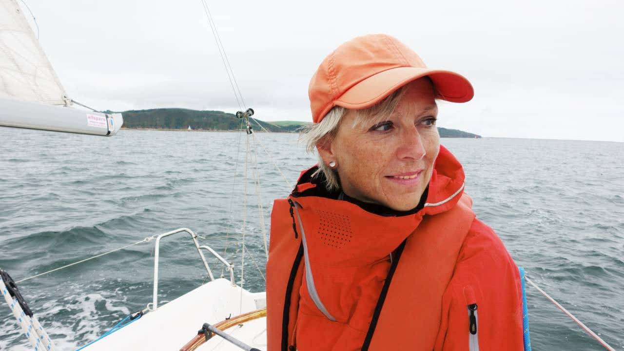 Mature lady on sailing boat