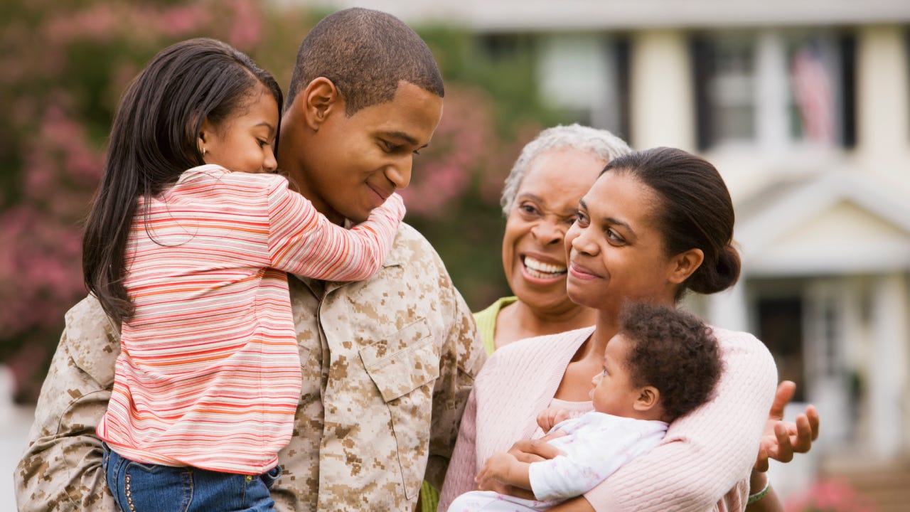 Military father hugging family