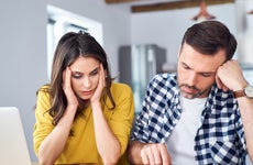 distressed couple with financial documents