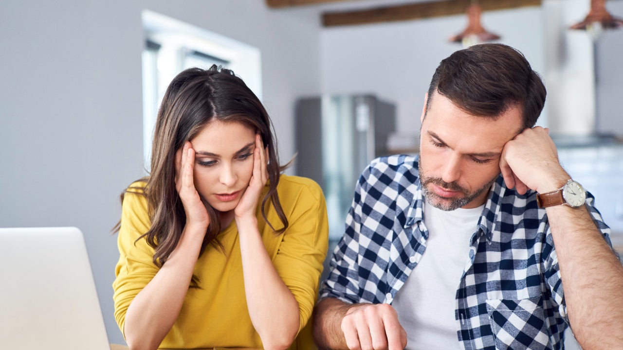 distressed couple with financial documents