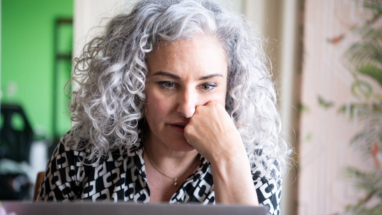 gray-haired woman working at home