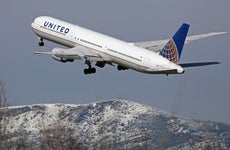 A view of a United Airlines plane at Barcelona Airport in Barcelona, Spain, on February 27, 2023. Snow is falling in Barcelona, covering the mountains of the Collserola mountain range in white