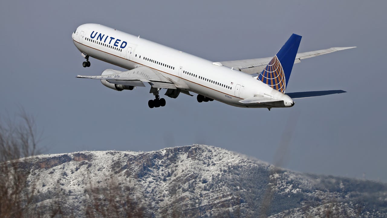 A view of a United Airlines plane at Barcelona Airport in Barcelona, Spain, on February 27, 2023. Snow is falling in Barcelona, covering the mountains of the Collserola mountain range in white