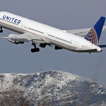 A view of a United Airlines plane at Barcelona Airport in Barcelona, Spain, on February 27, 2023. Snow is falling in Barcelona, covering the mountains of the Collserola mountain range in white