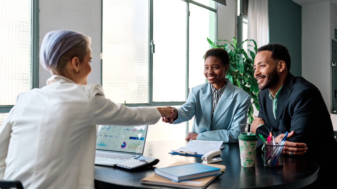 Businesswoman closing a deal with clients