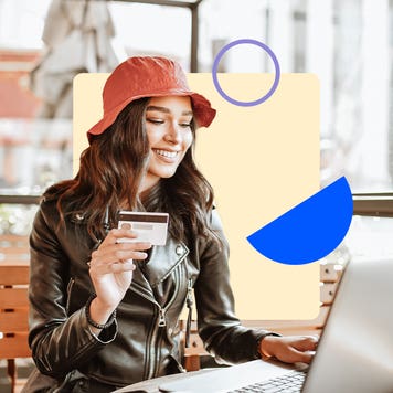 design element featuring a women wearing a bucket hat and on her laptop holding a credit card