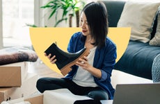 design element of a women sitting on a couch in a living room holding a boot