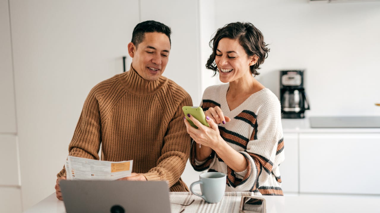 couple in the kitchen with bills