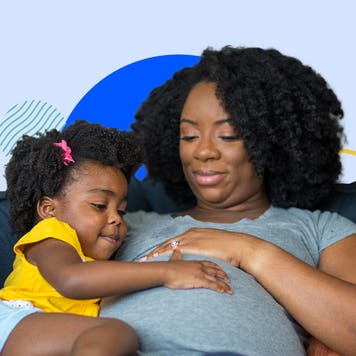 Pregnant black parent with black child feeling baby kick