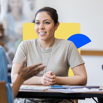 A smiling female military veteran speaks with a loan officer.