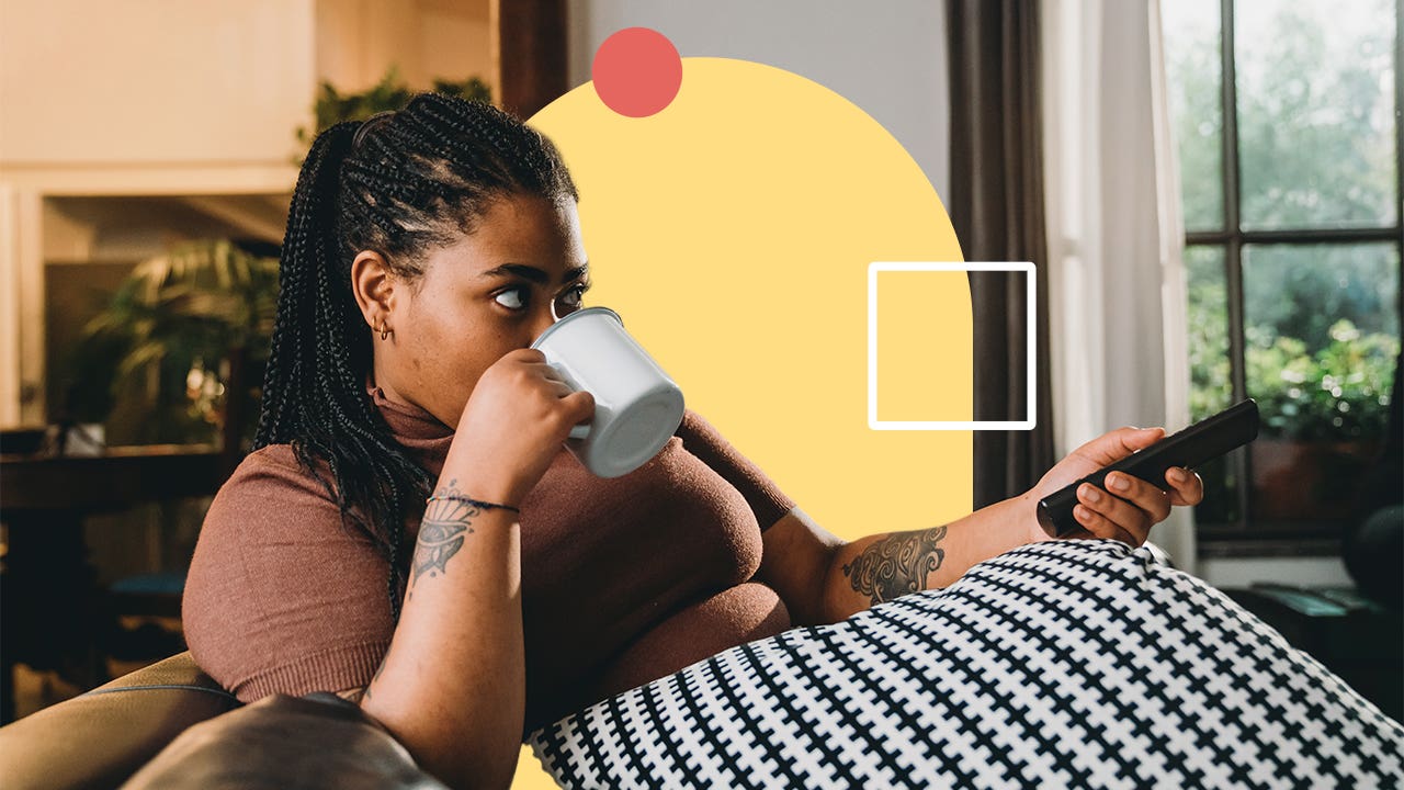 Young woman sipping coffee on couch