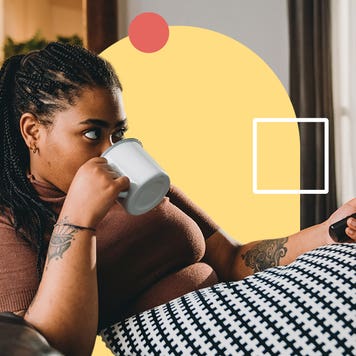 Young woman sipping coffee on couch