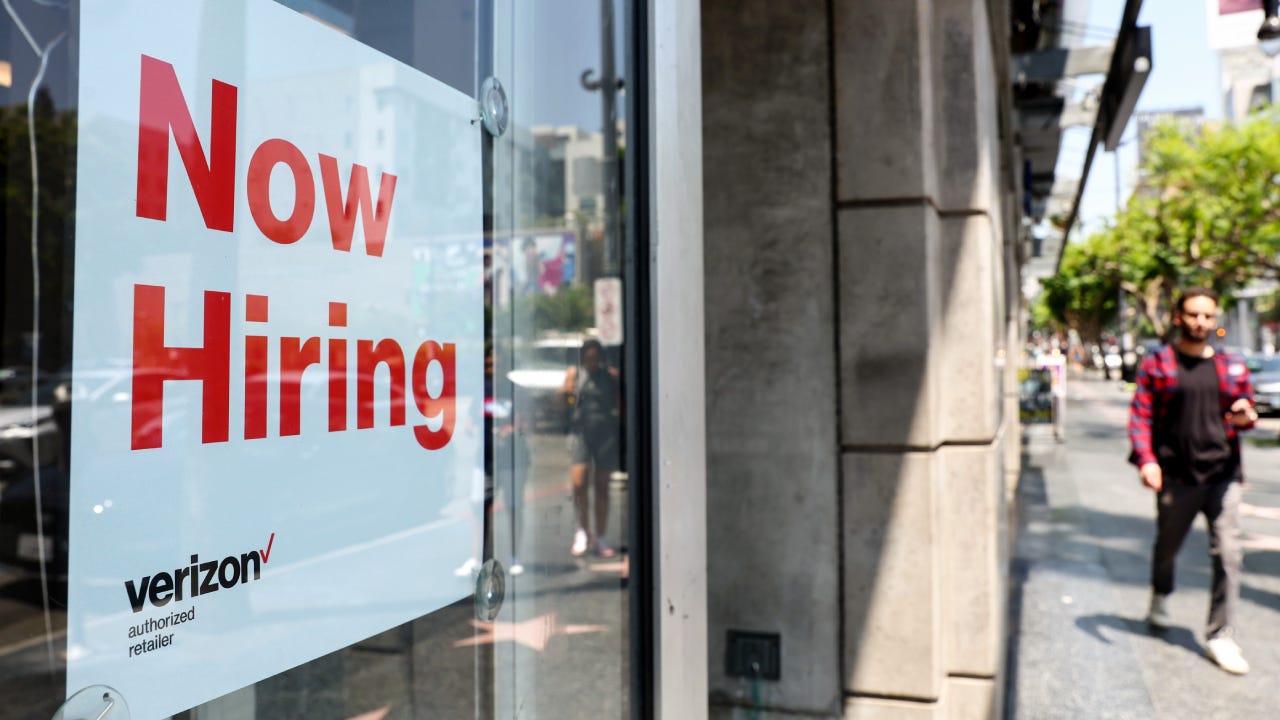 Now hiring sign in a shop window