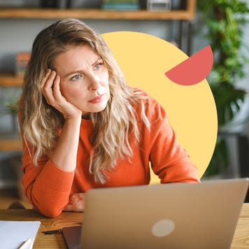 A white woman sitting in front of a laptop at a table looking thoughtful. There is an illustrated element of a yellow circle behind her and a small red half circle on it.