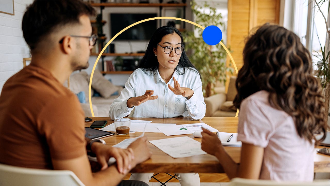 Two people meeting with an agent