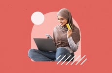 Woman on laptop with salmon-colored background