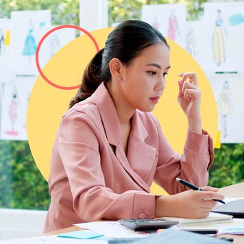 Business owner sits at desk working.