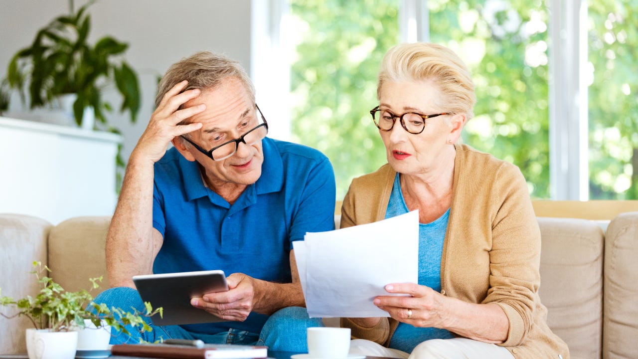 Senior couple looking at financial documents