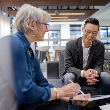 Loan manager meeting with happy couple in bank branch