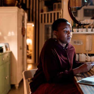 Close up of a young woman doing her home finances in the evening