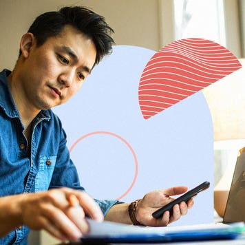 Man working on laptop and cellphone simultaneously