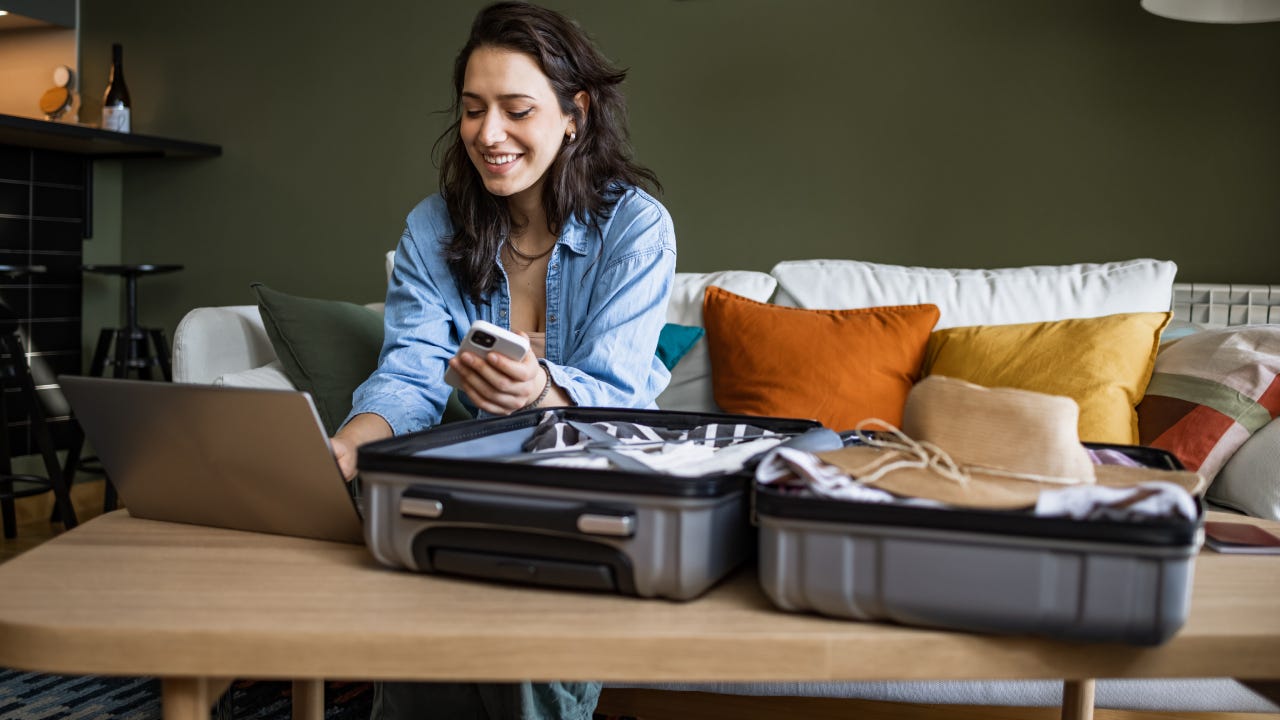 Woman using laptop to book travel reservation