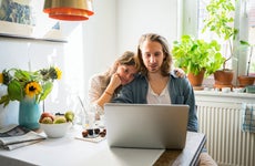 Young couple using laptop in kitchen