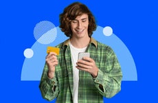 design element including a young adult smiling while holding a phone one in hand and a card in the other